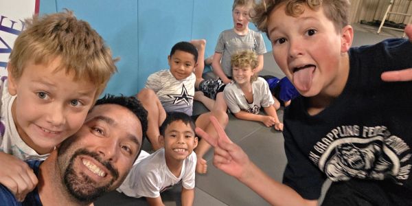 Group selfie with smiling and playful kids.