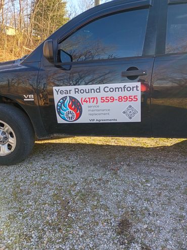 year round comfort truck magnets on a black service truck.