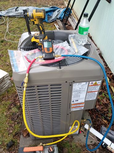 Outdoor AC condenser being installed Reeds Spring, MO