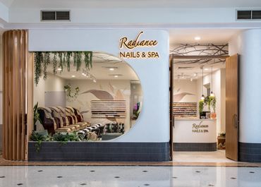 Retail shopfront design with layered textures, illuminated signage and curved display window.