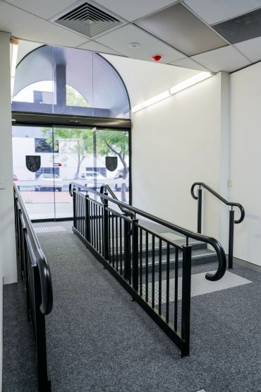 Entrance ramp & stairs in building lobby.