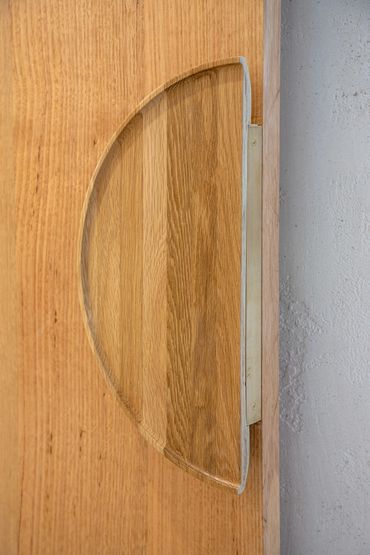 Feature timber half moon door handle.