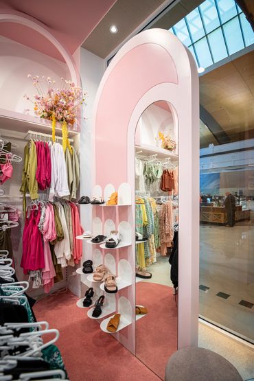 Pink arched shoe display.