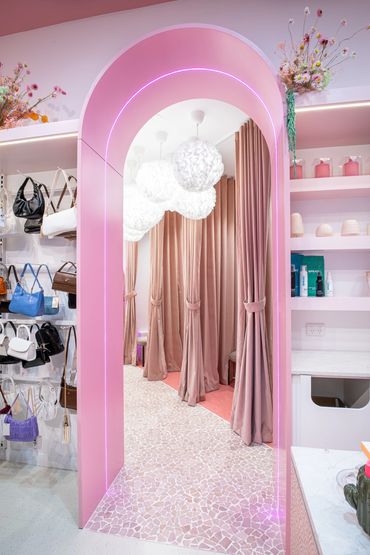 Large pink archway, cloud-shaped pendants and floor to ceiling velvet curtains.