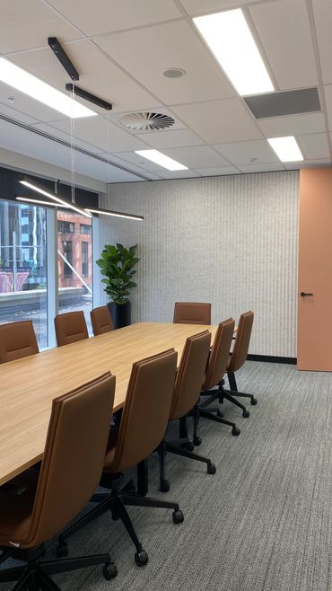 Boardroom chairs and table with feature wall acoustic panelling.