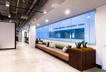 Breakout space within office fitout with custom booth seating and built in planter boxes.