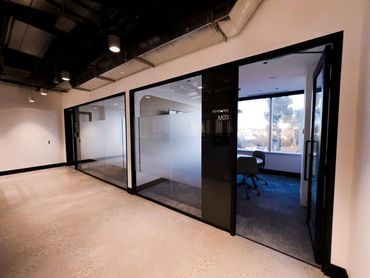 Meeting rooms featuring dusted crystal glazing film and black powdercoat framing.