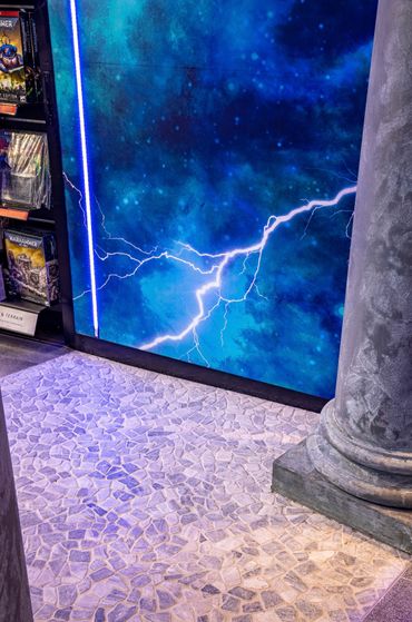 Retail design feature faux columns, feature wall paper and crazy paving flooring.