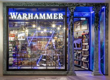 Shopfront design with illuminated signage, feature graphics and LED strip lighting.