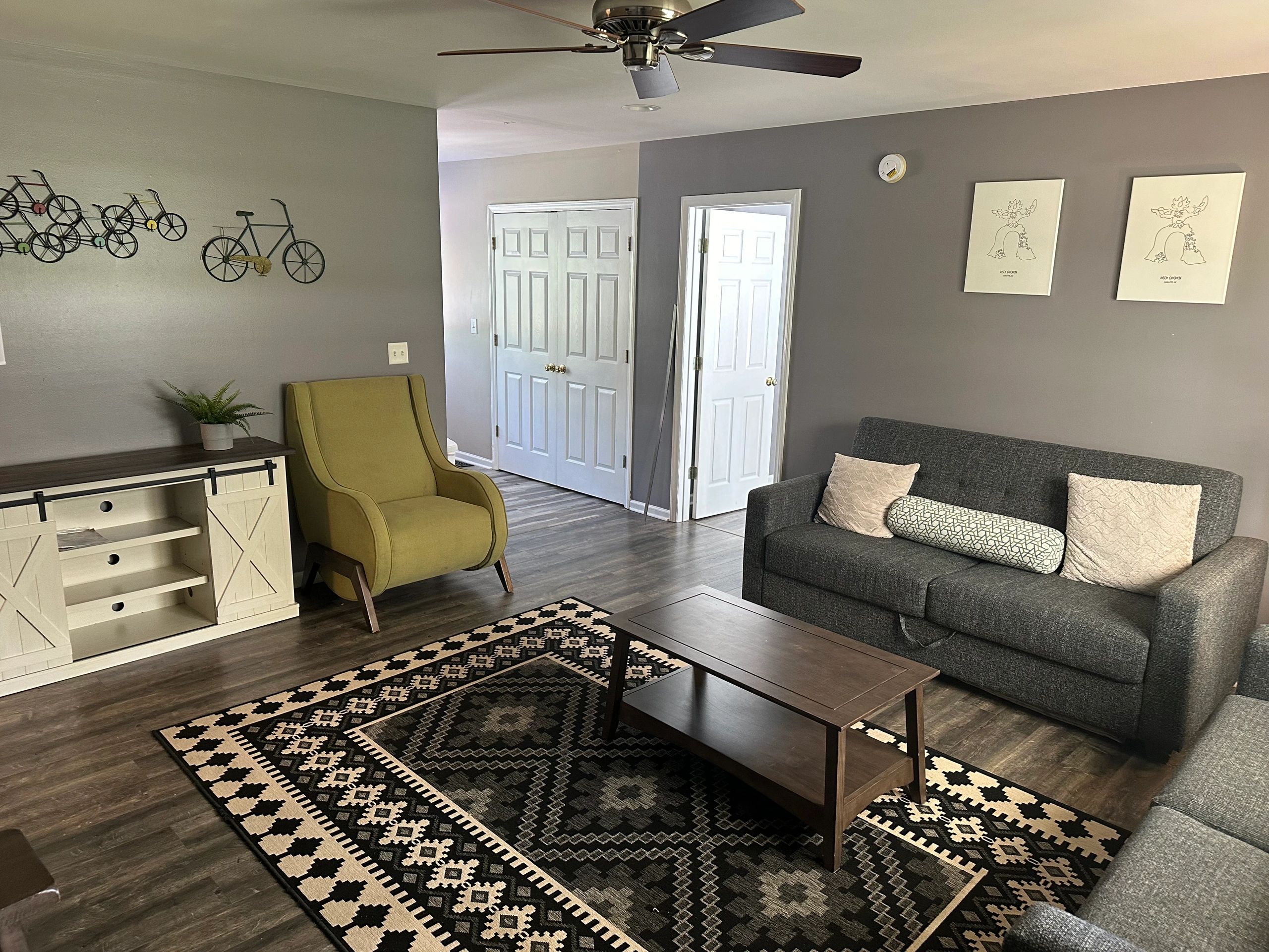 Cozy living room with gray sofa and yellow chair.
