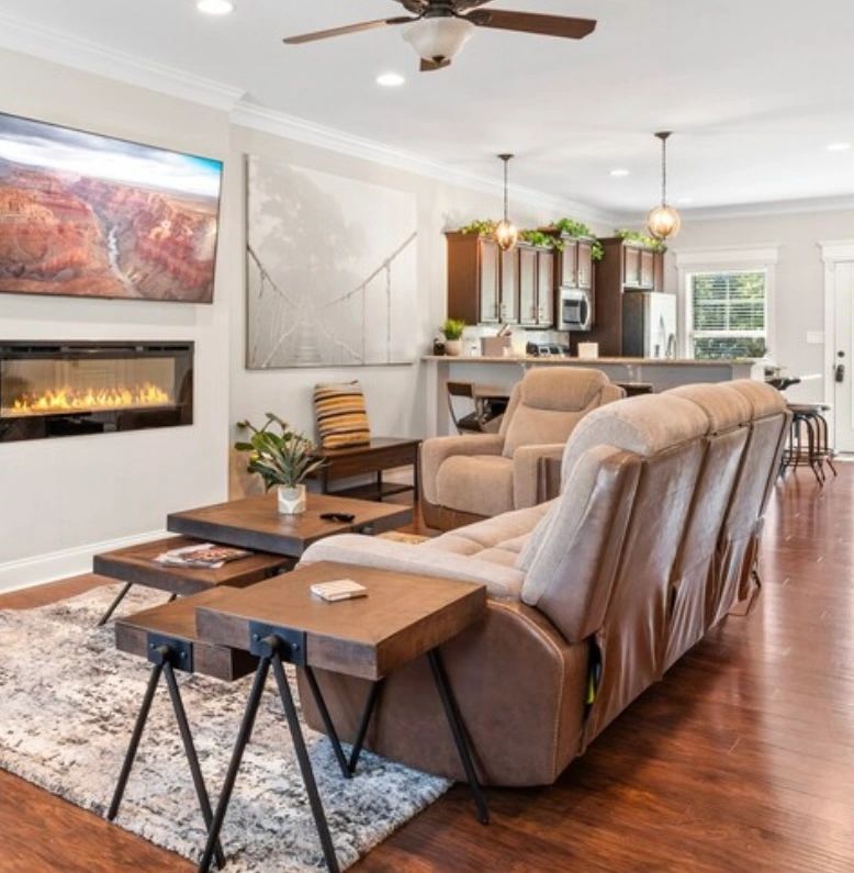 Modern living room with a fireplace and open kitchen.
