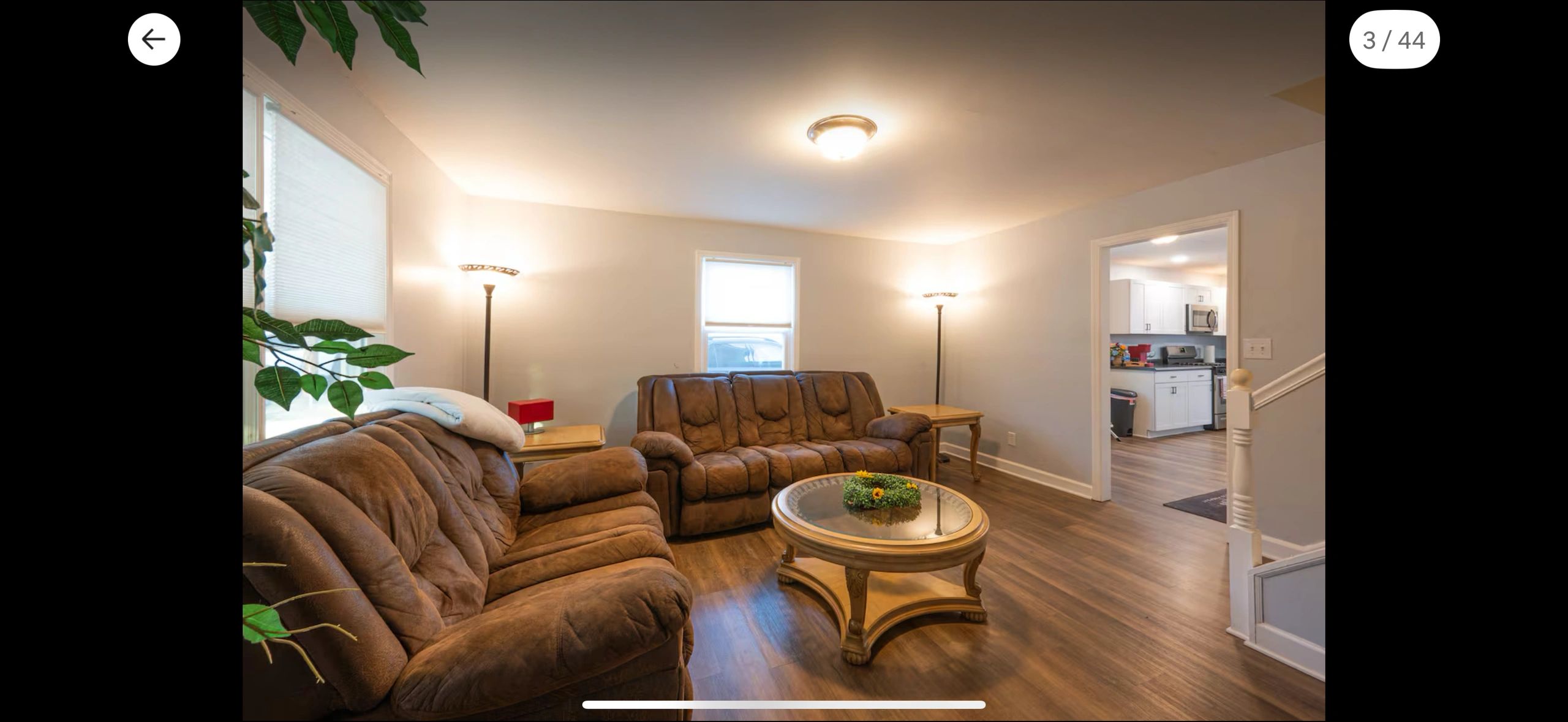 Cozy living room with brown sofas and wooden coffee table.