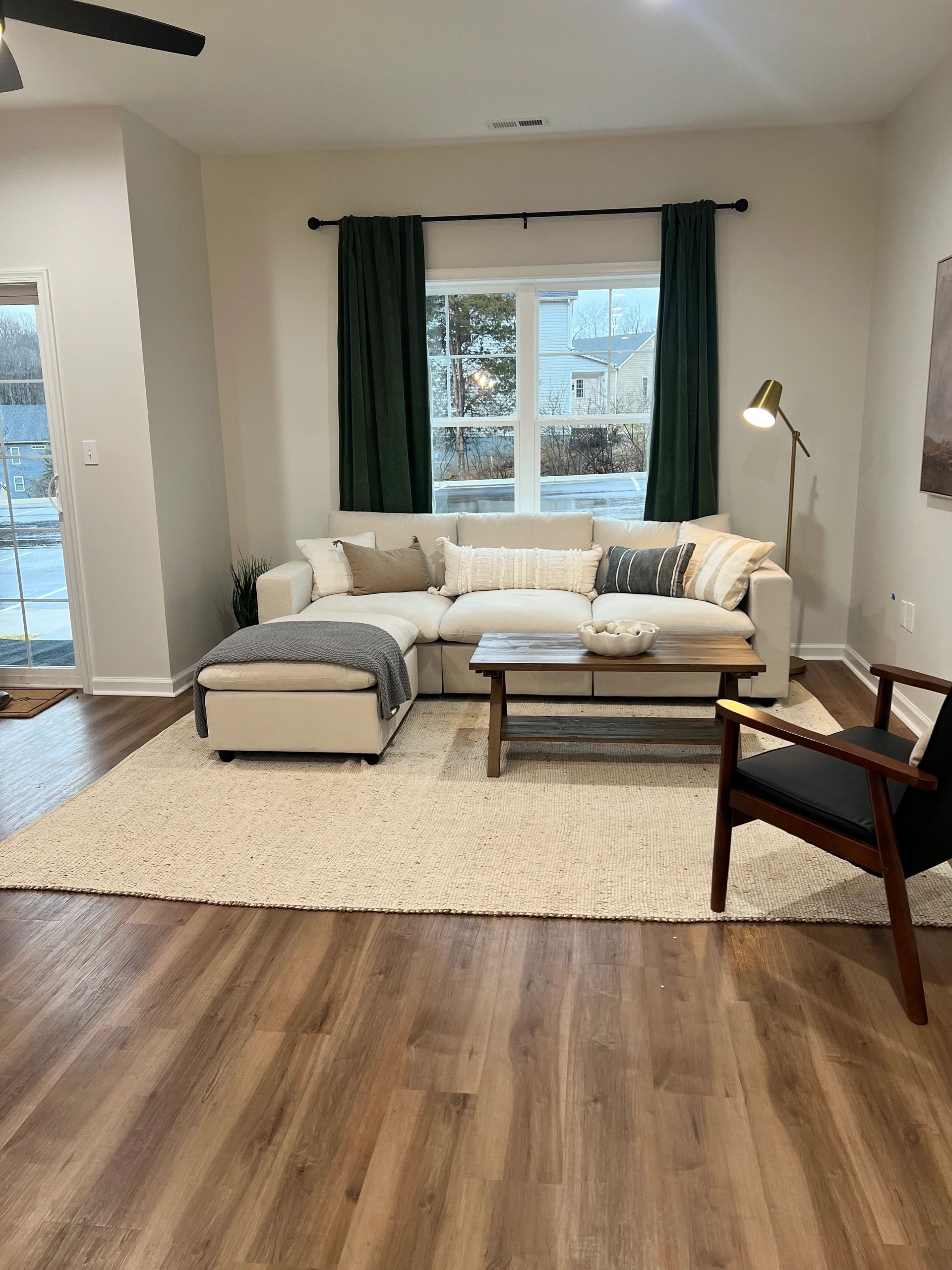 Cozy living room with beige sofa and wooden coffee table.