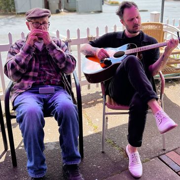 Music director playing the guitar with senior in Tigard, OR.