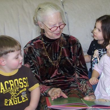 Children and a grandparent enjoy reading time at Gentog Intergenerational Daycare in Tigard, OR