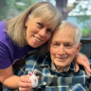 Senior Care Director & elder smile together for a picture while at Gentog Senior Daycare in Tigard,