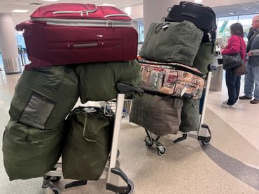 Zhalman and team traveling through the airport with supplies to deliver for the orphanage