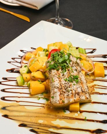 Grilled fish fillet with fresh mango salsa and balsamic glaze drizzle at Mangia E Bevi