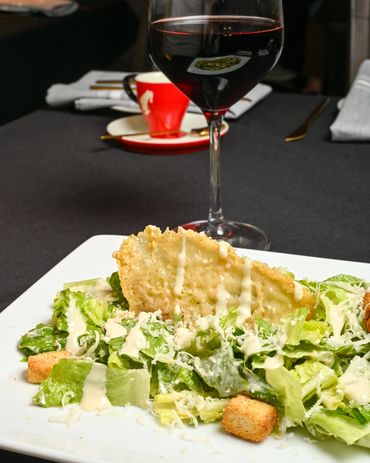 Classic Caesar salad with parmesan crisp, croutons, and red wine at Mangia E Bevi