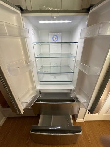 sparkling clean refrigerator in Benicia, California, with polished shelves and gleaming doors after
