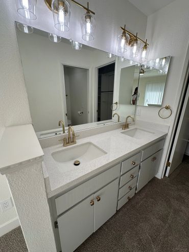 Move Out Clean in Livermore for a two-person, vanity station with white cabinets and quartz counters