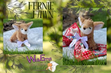 Plush baby buck holding a quilt.