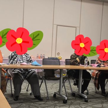 People seated around a conference table in a meeting room.