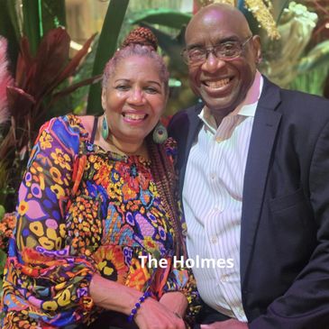 Smiling couple dressed elegantly, posing warmly indoors.