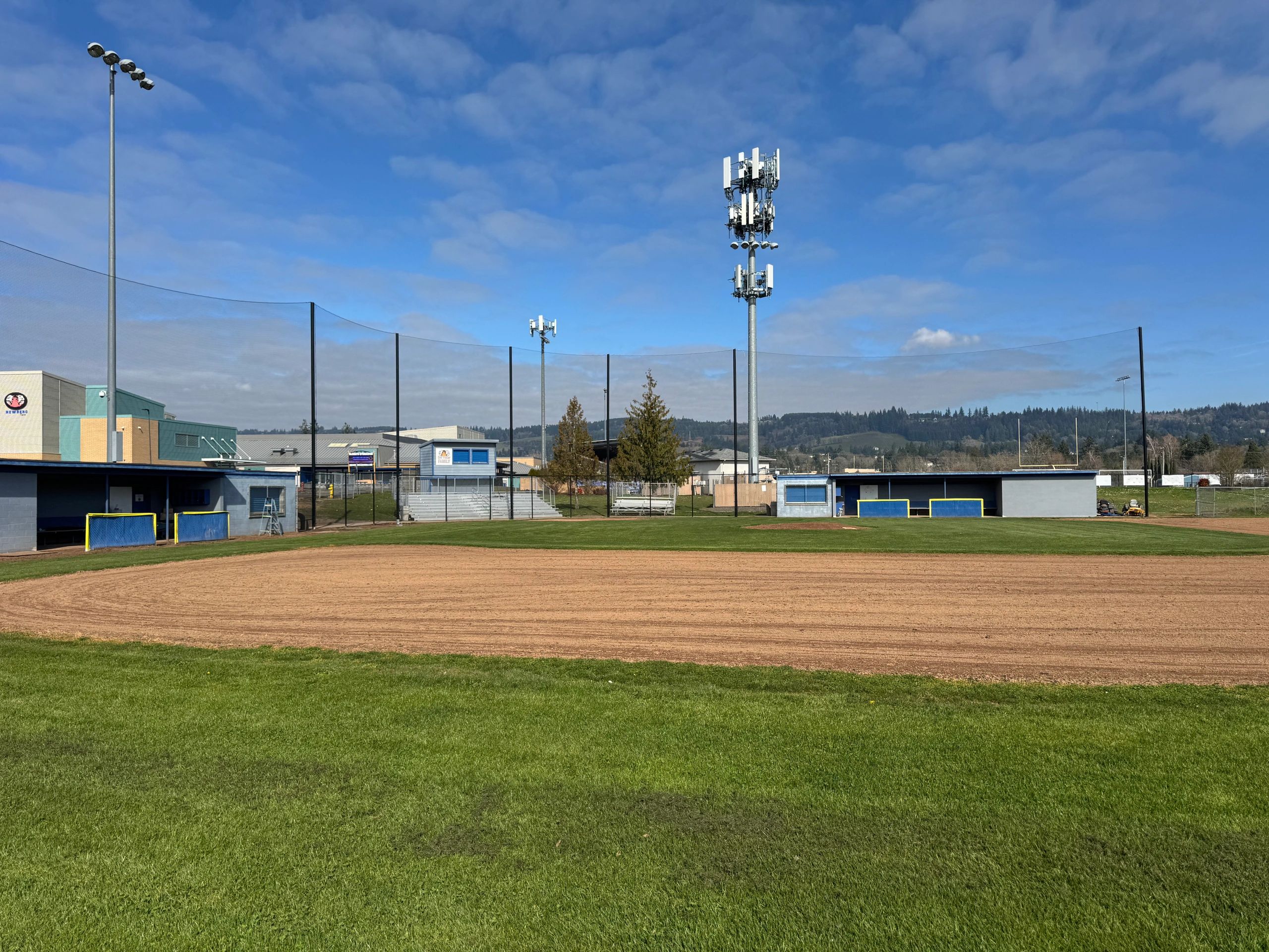 Stack of books next to pencils in a holder and a camera.