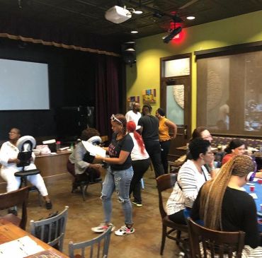 People gathering in a cozy room with massages and socializing, another Coffee, Tea and Sanity event by Nurturing Possibilties