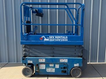 Genie scissor lift 1930 with tilt or drop deck trailer.  Rough terrain scissor lift or electric lift