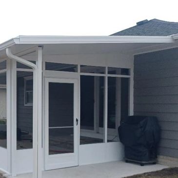 Beautiful Patio Screen Sunroom installation in Toms River with solid kneewall and swing door