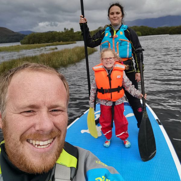 Explore the lakes family paddle board on Derwent water. 