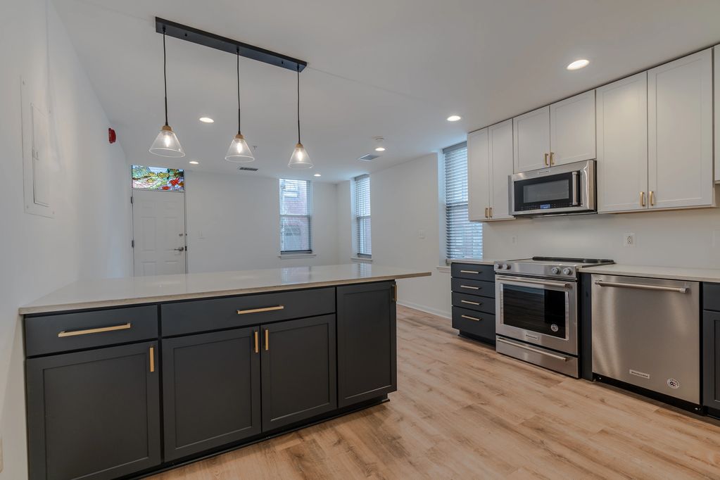 open floor plan kitchen and living space with large peninsula with storage