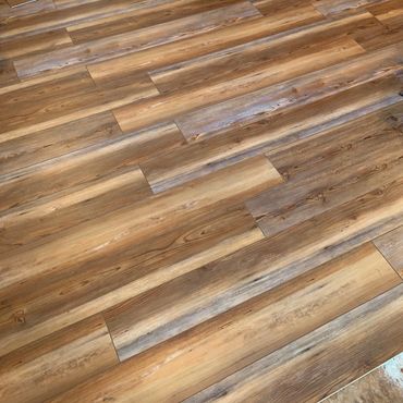 Wooden floor with varying shades of brown and natural grain patterns.