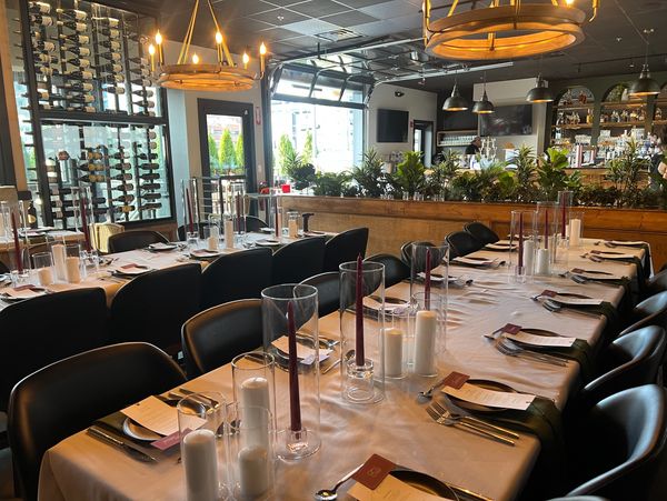 Elegant dining setup with candles and menus in a cozy restaurant.