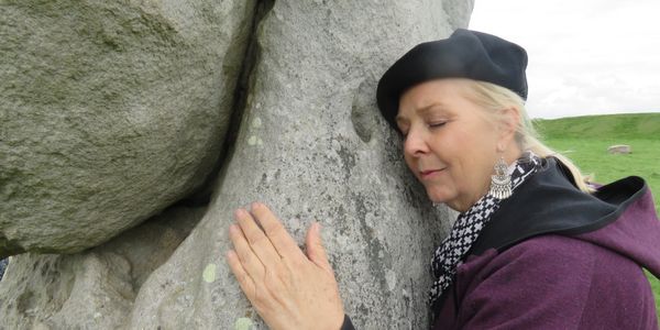 A woman hugging a rock
