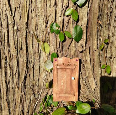 brown faerie door next to tree, inter-dimensional portal