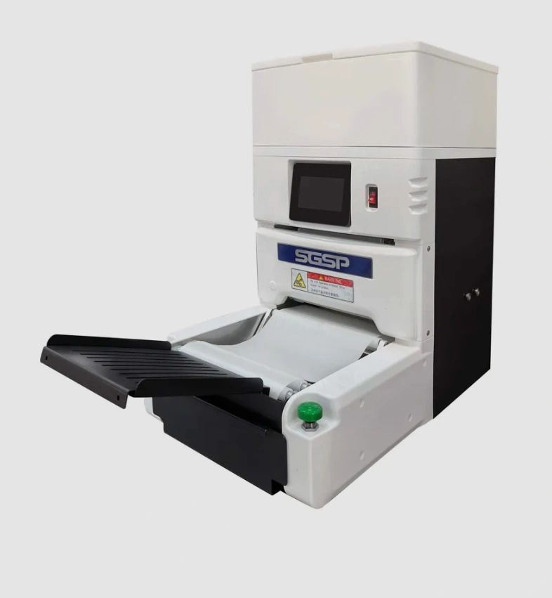Compact SGSP machine with a touchscreen and paper tray.