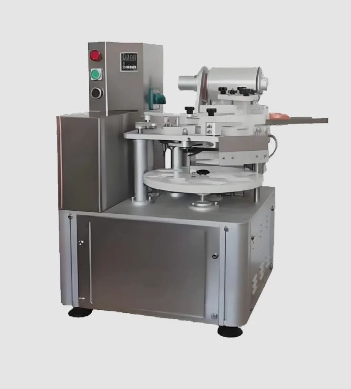 Industrial labeling machine with control buttons and rotating platform.