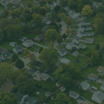 Aerial view of a suburban neighborhood with houses and trees.