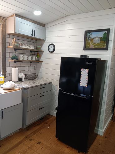 Our kitchen has a refrigerator/freezer, microwave, coffee maker, tea kettle, cookware & utensils.