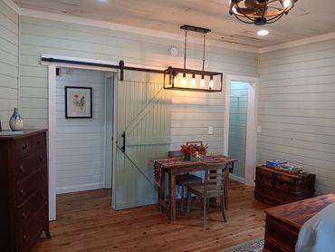 Bedroom 2 offers a work/dining table, closet, and 2 antique trunks for storage.