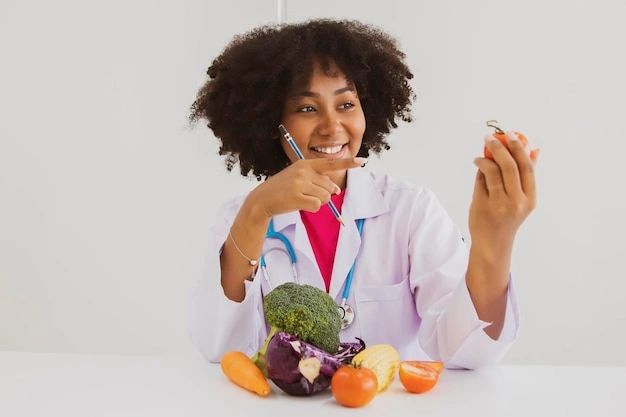 Smiling nutritionist holding a clock, promoting healthy eating habits.