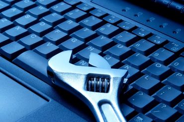 Wrench placed on a laptop keyboard.