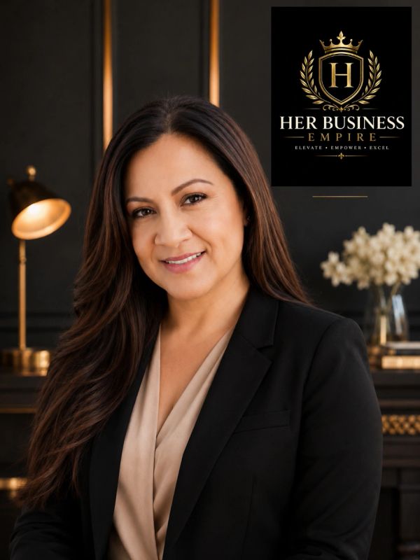 Professional woman posing in an elegant office with Her Business Empire logo.
