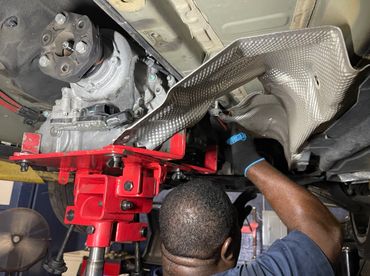 an experienced mechanic working under a car