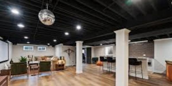 A luxury finished basement whree the client decided to eliminate the ceiling and paint the joist for