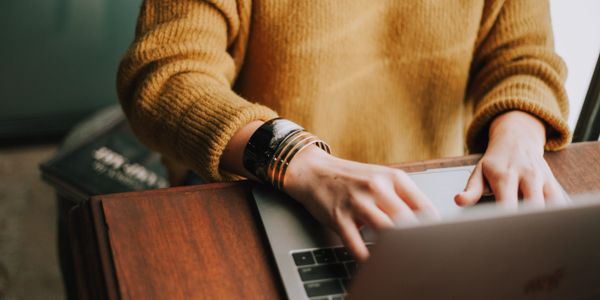 A woman typing on her laptop