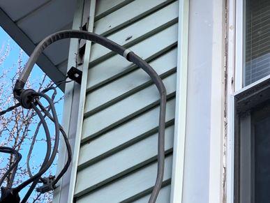 Electric Line pulling away from a house found during a home watch inspection.
